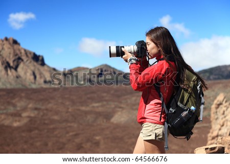 Nature Photographer taking pictures outdoors during hiking trip on Teide, Tenerife, Canary Islands.