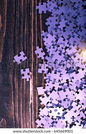 Puzzle and wooden background
