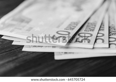 Euro banknotes on the wood rustic table. Black and white photo