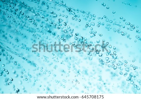 sprinkling water from shower head, closeup, blue toned photo.  Royalty-Free Stock Photo #645708175
