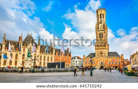 Market Square (Markt) Provincial government in Bruges, Belgium. View to Belfort tower building in historical centre of old town day panorama with blue sky and clouds. Royalty-Free Stock Photo #645710242
