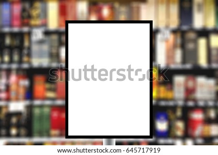 Blank standing sign with copy space for text message or mock up content in Abstract blur background of alcohol drink shelf.