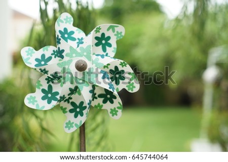 A picture of green pinwheel in a background of green garden.