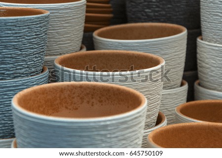 On a shelf of clay pots for flowers