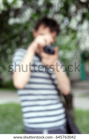 Man takes pictures, out of focus