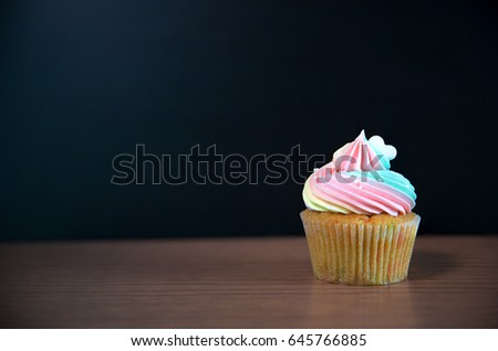 Birthday cupcake in front of a chalkboard.mini cake.chocolate cupcake with rainbow cream and heart for love valentines. image for background, wallpaper and copy space.