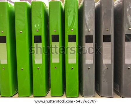 Green file And gray wrapped in clear plastic. Put on the floor, stationery