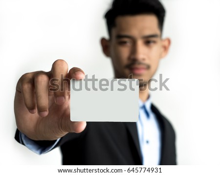 Businessman reach out on camera and show credit card or visit card, close up