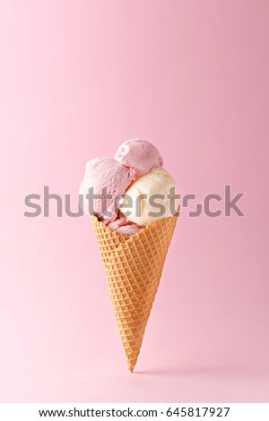 Ice cream cone vanilla and strawberry flavors on a pink background. Copy space Royalty-Free Stock Photo #645817927