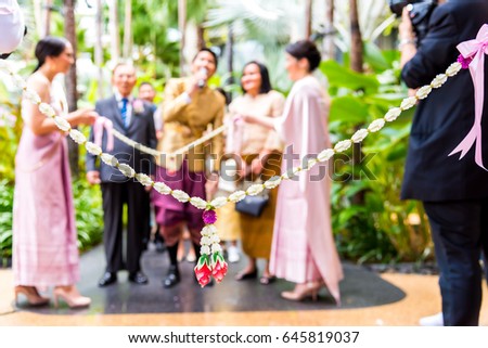 Blur picture of Bridesmaids Holding Garland Jasmine at the Opening Ceremony of Thai Wedding