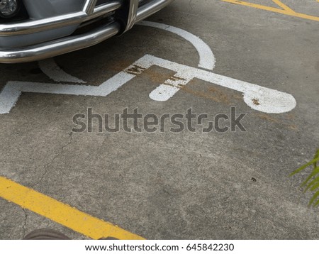 Cars coming to park for the disabled.