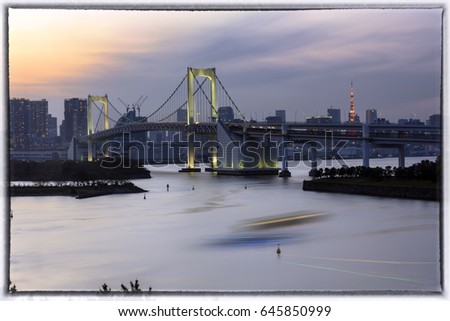 Bird eye view of  Rainbow Bridge from Odaiba . Odaiba  is a popular shopping and entertainment district on a man made island in Tokyo Bay Japan .