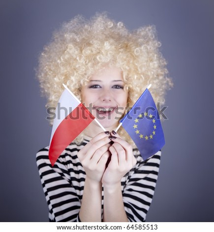 Beautiful girl with ringlets show European Union and Poland flag. Studio shot.