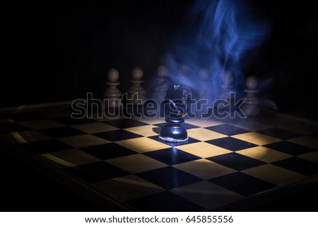 Chess game photographed on a chess board, black  horse and pawn