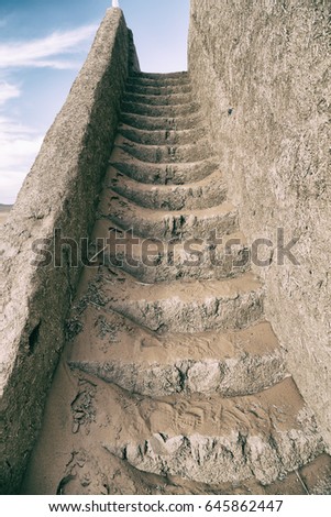 the old castle  stairs  dirty and full of desert sand    and sky