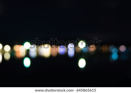 Abstract bokeh from light reflecting over sea at night.