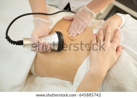 girl on anti-cellulite massage in the cabinet of cosmetology Royalty-Free Stock Photo #645885742