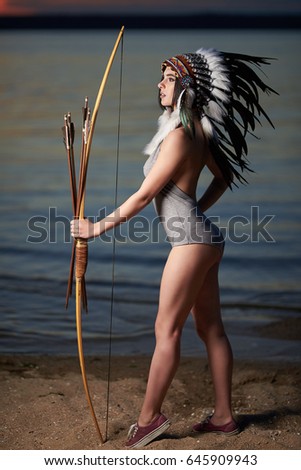 Beautiful girl in a headdress of American Indians