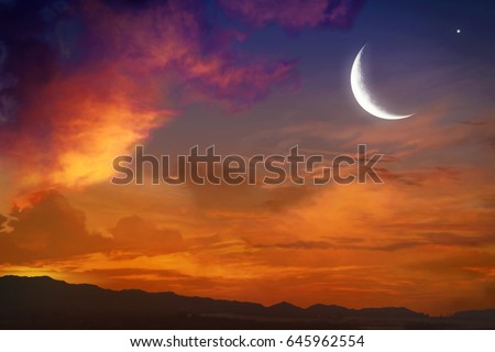 Red sunset and moon  .  Against the background of clouds . beautiful sky . NASA . Yellow and pink clouds . Sunset and new moon  .  Prayer time  .   Generous Ramadan    Royalty-Free Stock Photo #645962554