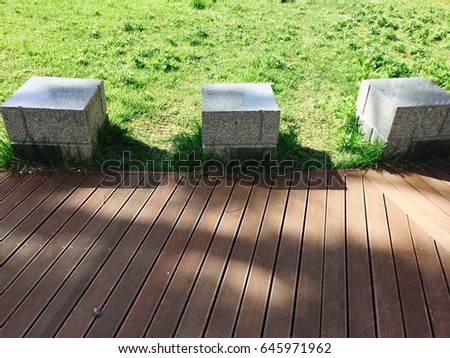 Three cubic chairs at a garden