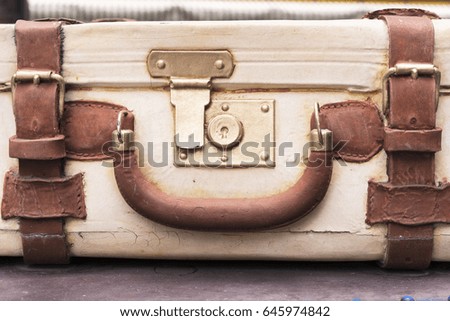 An Old Vintage Suitcase With Leather Straps Royalty-Free Stock Photo #645974842