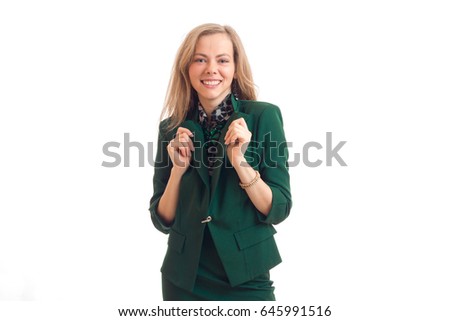 beautiful young girl in jacket laughs looks straight and keeps hands collar