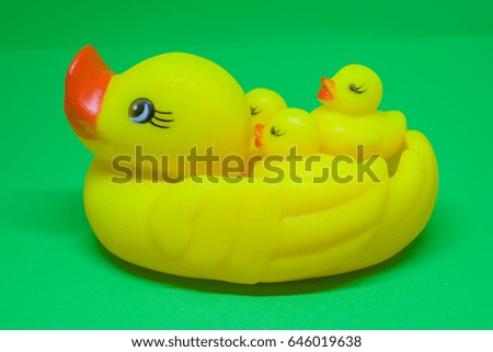 Close Up of yellow rubber ducks, green background