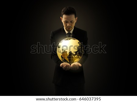 Businessman with suit holding and looking 3D golden planet