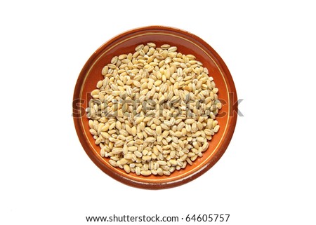 Pearl barley on a dish. Isolated over white background.