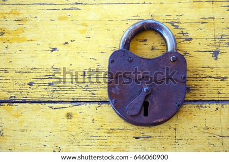 Old lock on the background of wooden boards painted with yellow paint 6.