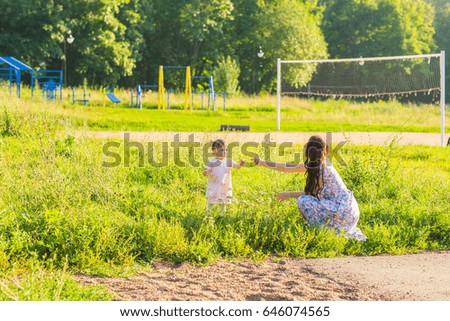 Happy cheerful family. Mother and baby have fun in nature outdoors