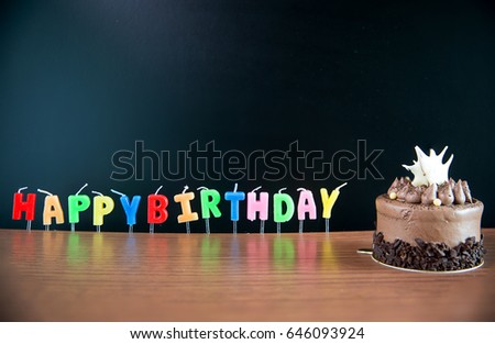 Candlestick alphabet word happy birthday and  Birthday Mini chocolate cake with blackboard on wooden floor. image for background, wallpaper, copy space and greeting card