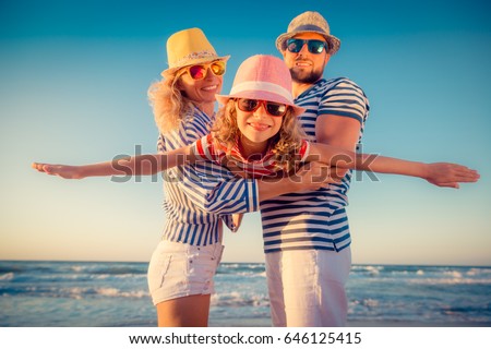 Happy family on the beach. People having fun on summer vacation. Father, mother and child against blue sea and sky background. Holiday travel concept Royalty-Free Stock Photo #646125415