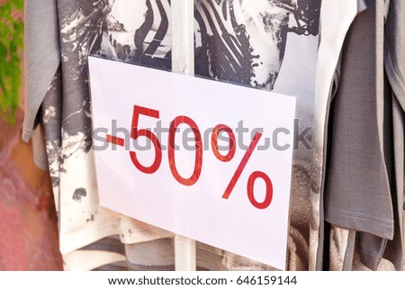 Signboard 50% discount hanging in the clothing store