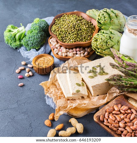 Assortment of healthy vegan protein source and body building food. Tofu soy milk beans asparagus broccoli artichokes almond peanut pumpkin chia flax seeds quinoa oat meal