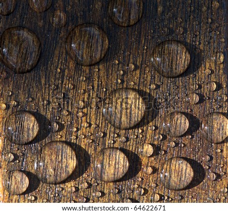 Water drops magnified on wood grain Royalty-Free Stock Photo #64622671