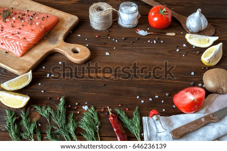 salmon fish fillets cutting board fresh ingredients cooking rustic background. Top view, frame. Healthy diet food