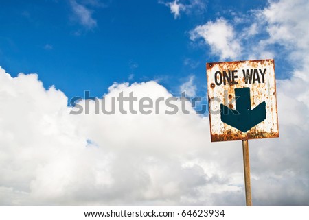 one way road sign on cloud blue sky