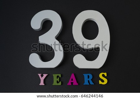 Letters and numbers thirty-nine years on a black isolated background.
