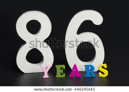 Letters and numbers eighty-six years on a black isolated background.