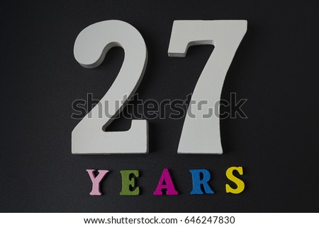 Letters and numbers twenty-seven years on a black isolated background.