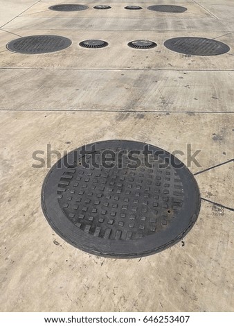 Black lid on the concrete floor