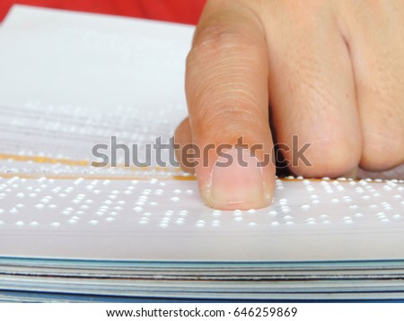 finger reading braille alphabet.          