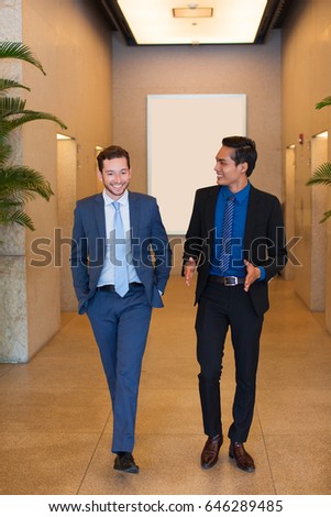Happy Coworkers Walking in Office Corridor