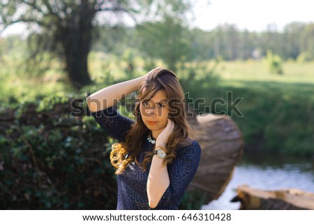 Young beautiful girl in the nature of a spring forest on a sunny