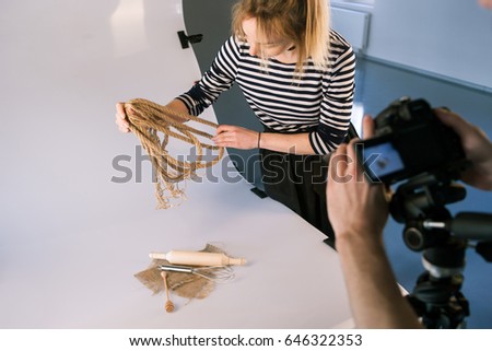 Handmade still life professional photoshoot. Unrecognizable photographer taking shots of domestic decor. Backstage of photo session with assistant.