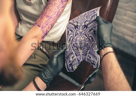 It is your future tattoo. Man showing how it looks on arm of client