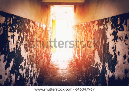 Corridor with peeling walls, light at the end of the tunnel concept