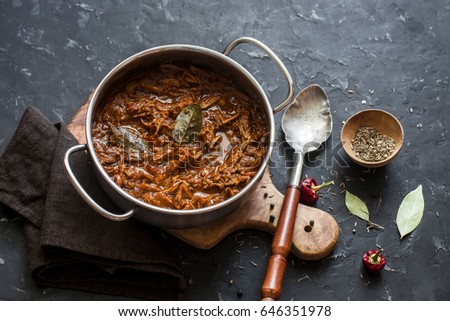 Slow cooker beef ragu. Crock pot braised beef on dark background. Delicious comfort healthy food   Royalty-Free Stock Photo #646351978