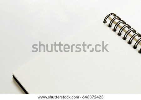 Open notebook on white background, Top view.